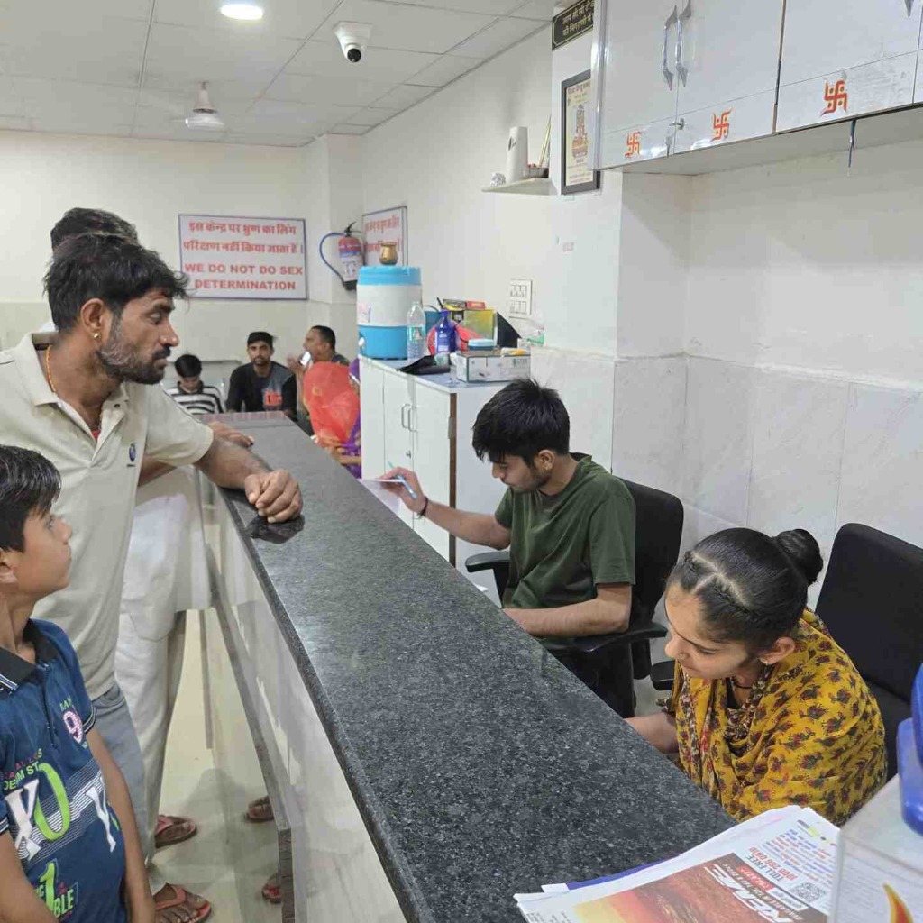 Front reception desk with staff assisting patients at Kedar CT & MRI Centre, Barmer